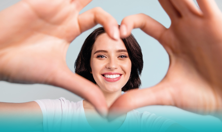 Campagna Bonus Idrico Integrativo 20256 donna che sorride rivolta all'obiettivo e crea un cuore con le loro mani